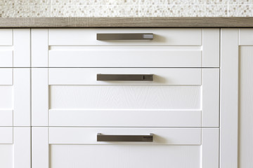 Close-up of white wooden facade of a traditional style kitchen 
