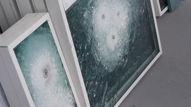 Closeup Shot of Worker`s Hands Replacing Window Frames With Bulletproof Glass With Holes From Bullets, Cracks and Fractures