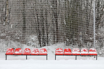 empty seats in a stadium in the snow