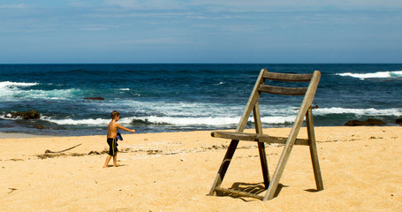 Child And Chair On Beach