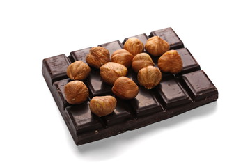 chocolate bars and pile hazelnuts isolated on white background