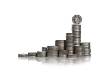 Large group of coins stacked in piles with swiss franc coin on t