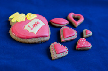 Composition of heart shaped honey cakes on blue background