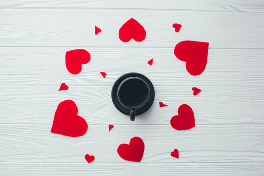 cup of coffee and red hearts  on a white background