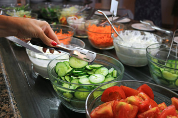 Sorted fresh salads displayed on a buffet in restaurant