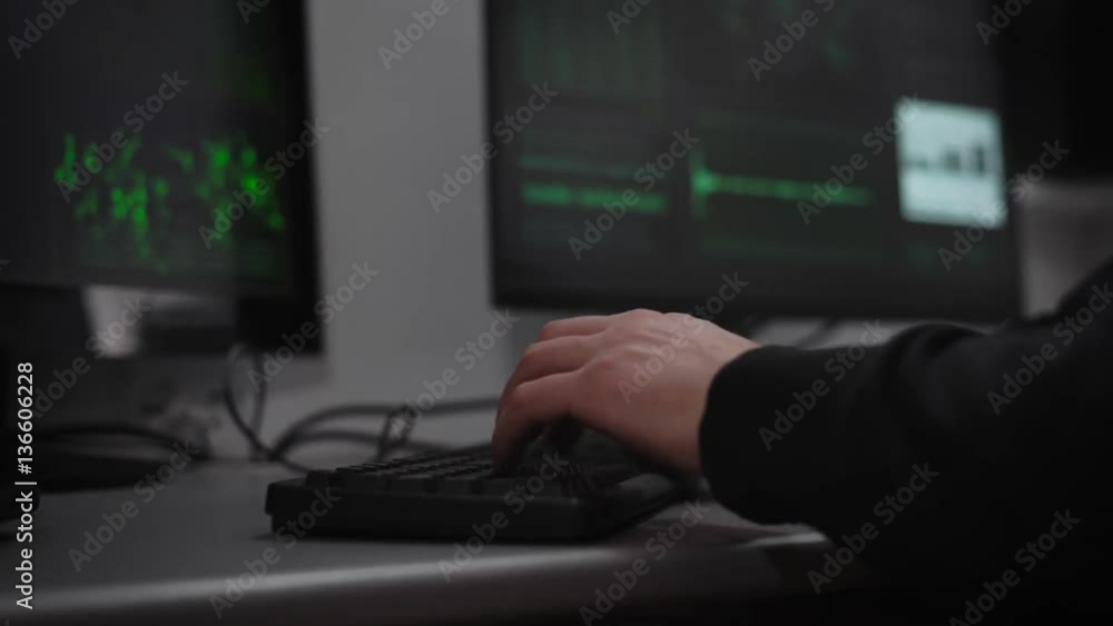 Poster a hacker is preparing for cyber-attack in the underground computer room. a man at a rapid pace enter