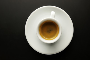 A cup of fragrant coffee on a black background.