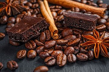 Coffee cup, spices and chocolate on wooden table texture with co