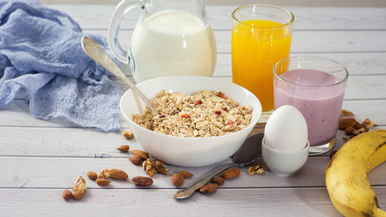 Breakfast table with muesli, egg, smoothie and banana