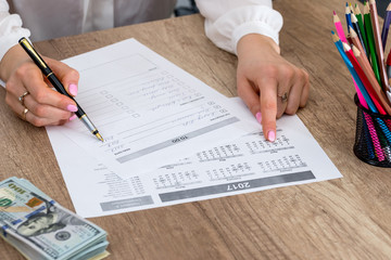 Woman checking completed in to-do list at office.