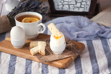 Fototapeta na wymiar breakfast with boiled eggs and crispy toasts, closeup
