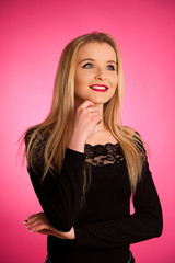 Fototapeta premium Portrait of a beautiful teenage girl over pink background
