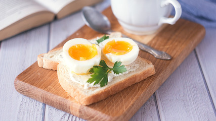 freshly boiled white egg on wooden board. Healthy fitness breakfast