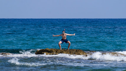 Fototapeta premium alone man on the reef in a mask for diving