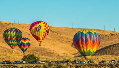 Four Hot Air Balloons Near Parking