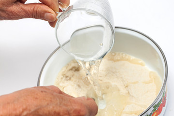 Colombian arepa dough preparation: Add salted warm water to the cornmeal