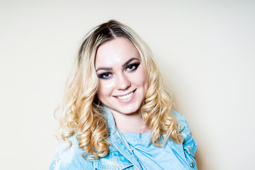 Fototapeta premium Girl blonde eye make-up on a light background