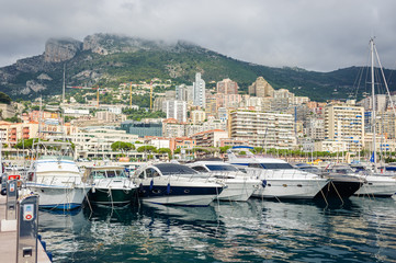 Fototapeta na wymiar The Principality of Monaco - July, 2016: Monte Carlo harbour city panorama. View of luxury yachts and apartments in harbor of Monaco, Cote d'Azur.