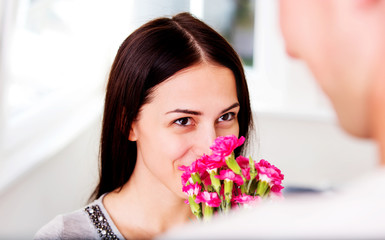 Men giving flowers to his lover woman.