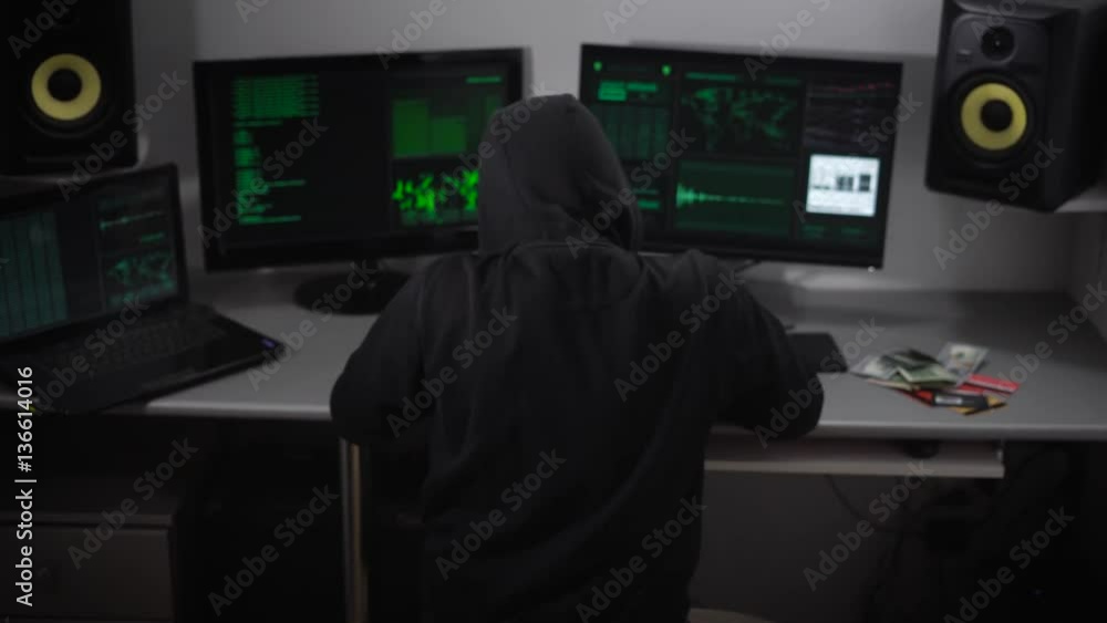 Poster hacker thinks about how his hack program and then abruptly turns to the monitor screen and starts wo