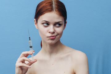 perplexed woman with a syringe in her hand