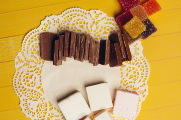 openwork napkin and pieces of chocolate, colorful marmalade, jelly
