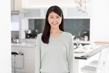 portrait of attractive asian woman in the kitchen