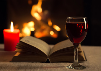 Open book with glass of red wine