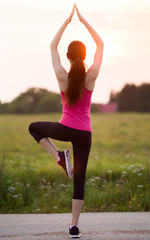 Sportive girl exercising outdoor. Woman doing sports.