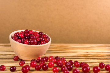 Cranberry. Cranberries on glay Plate Wooden Background