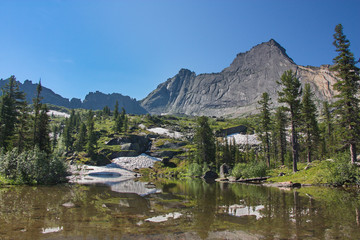 the view of the rock Sleeping Sayan  from the coast of the lake Azure in Sayan Mountains