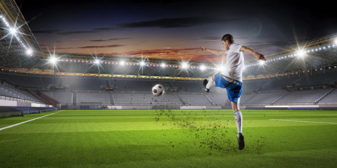 Soccer player at sport arena . Mixed media