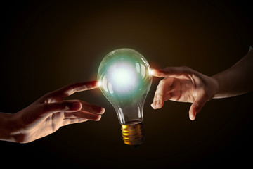 Hand pointing light bulb . Mixed media