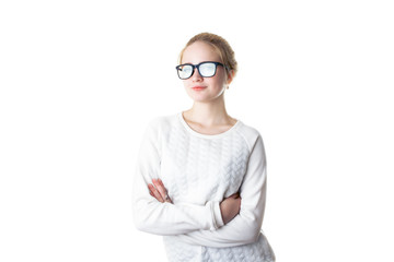 Girl teenager in glasses and a white sweater, crossed her arms and smiles. Isolated on white background
