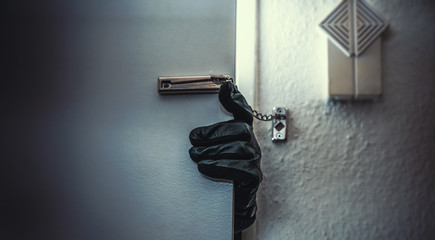burglar open door of apartment or house - obrazy, fototapety, plakaty
