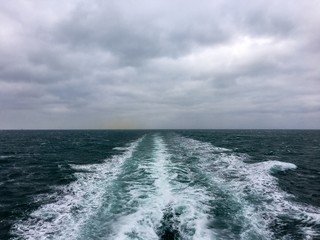 Cruise ship`s wake in rough sea