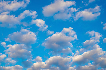 Blue sky background with white clouds.