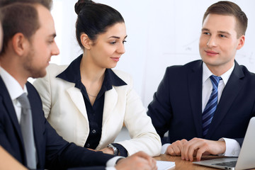 Group of business people and lawyers discussing contract papers at meeting