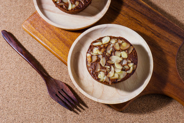 Homemade delicious fresh chocolate and almonds cake on wooden ta