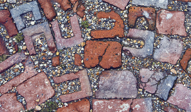 Rustic broken brick paving set in gravel - Powered by Adobe