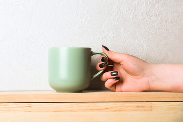 green tea or coffee cup in hand on white background