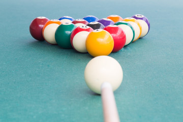 Cue aiming white ball to break snooker billards on table