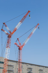 Fototapeta na wymiar Close - up big red crane at construction site