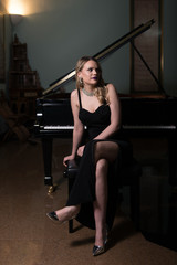 Fototapeta na wymiar Beautiful Young Woman Playing the Piano