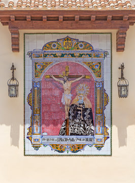MALAGA, SPAIN - MAY 25, 2015: The ceramic tiled, cried Madonna under the Crucifixion on the facade of church Parroquia de San Pedro (St. Peters church) by Ceramica Antonio Vadillo Plata (20 cent.).