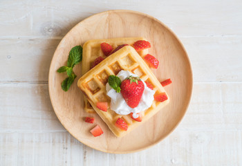 waffle with strawberry on wood