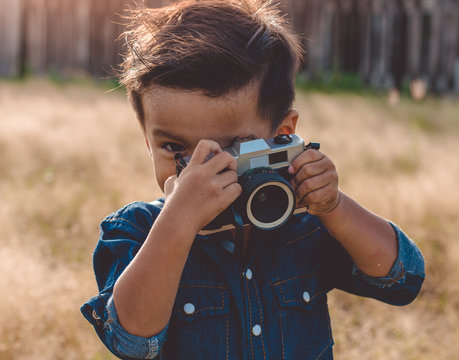 Little boy with a vintage camera,photographer boy
