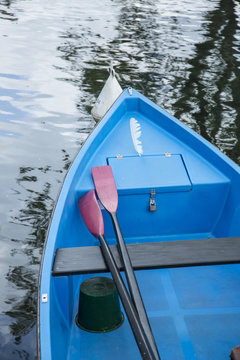 Blue boat on the water and paddle