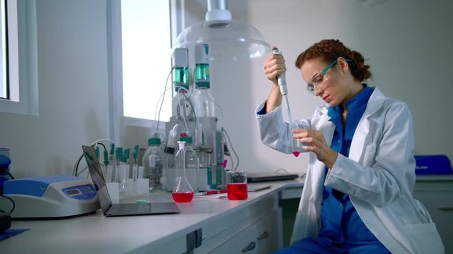 Medical research. Science doctor working in lab. Woman doctor scientist doing research medicine. Medical research lab. Lab doctor working with liquid in glass flask. Female doctor in lab medical