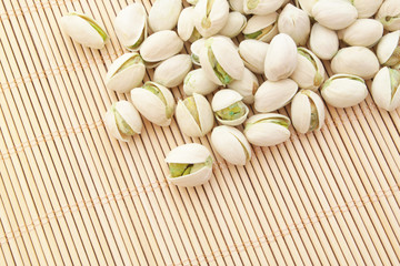Pistachio nuts on bamboo background